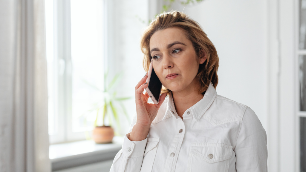 She Was The Stores Most Trusted Worker — Then One Customer Took It Too Far And Contacted Her Privately woman on phone looking concerned