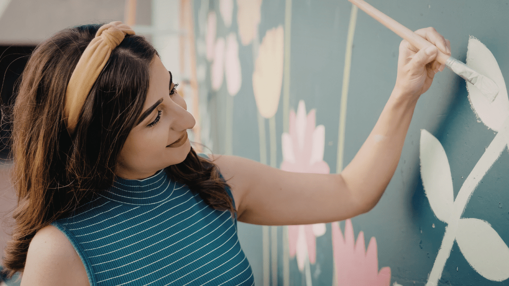 One Tenant Filled Her House With Murals, But When The Landlord Ended Her Stay, She Chose To Repaint Before Walking Away woman painting mural on wall