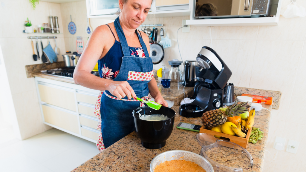 She Cooked Dinner for Her Own Kids—Now Her Mother in Law Is Calling Her Heartless for Not Feeding Her Nephews Too woman preparing food in the kitchen