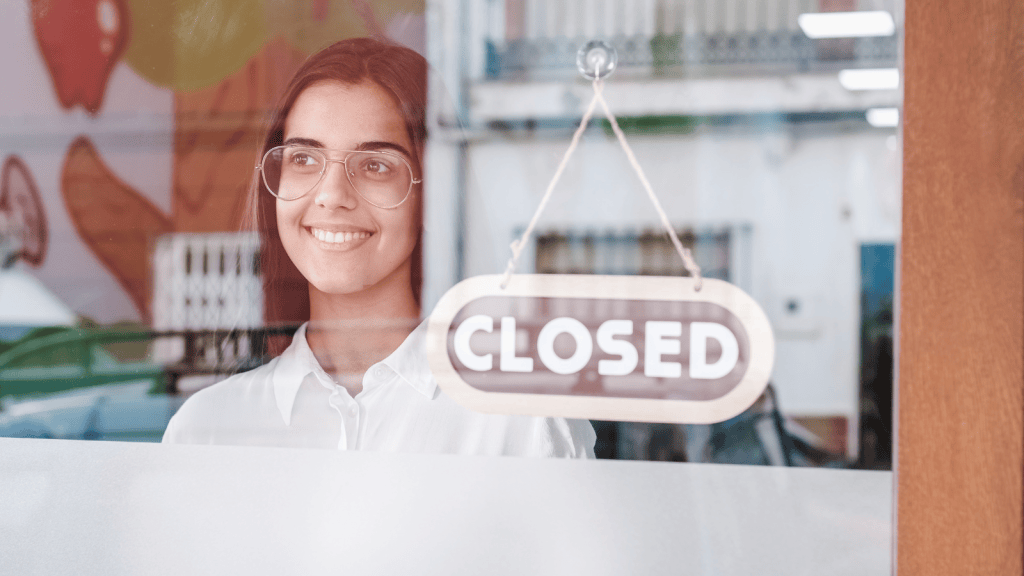 A Customer Rattled the Locked Doors 3 Minutes After Closing—So He Tapped His Watch and Refused to Unlock the Entrance woman putting up closed sign