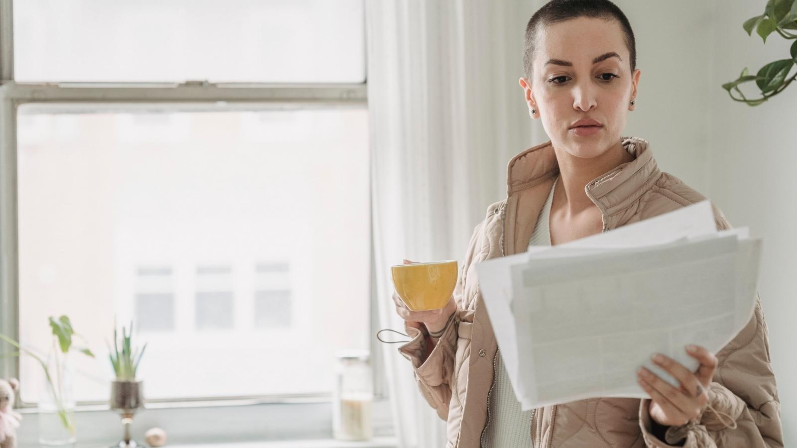 woman reading a stack of papers
