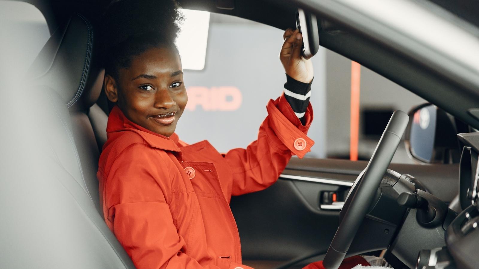 Her Neighbor Staged an Outrage Tirade Over His Street Space—Then She Left Her Car Parked Until the City Ticketed Him for False Reporting woman smiling in driver's seat of car