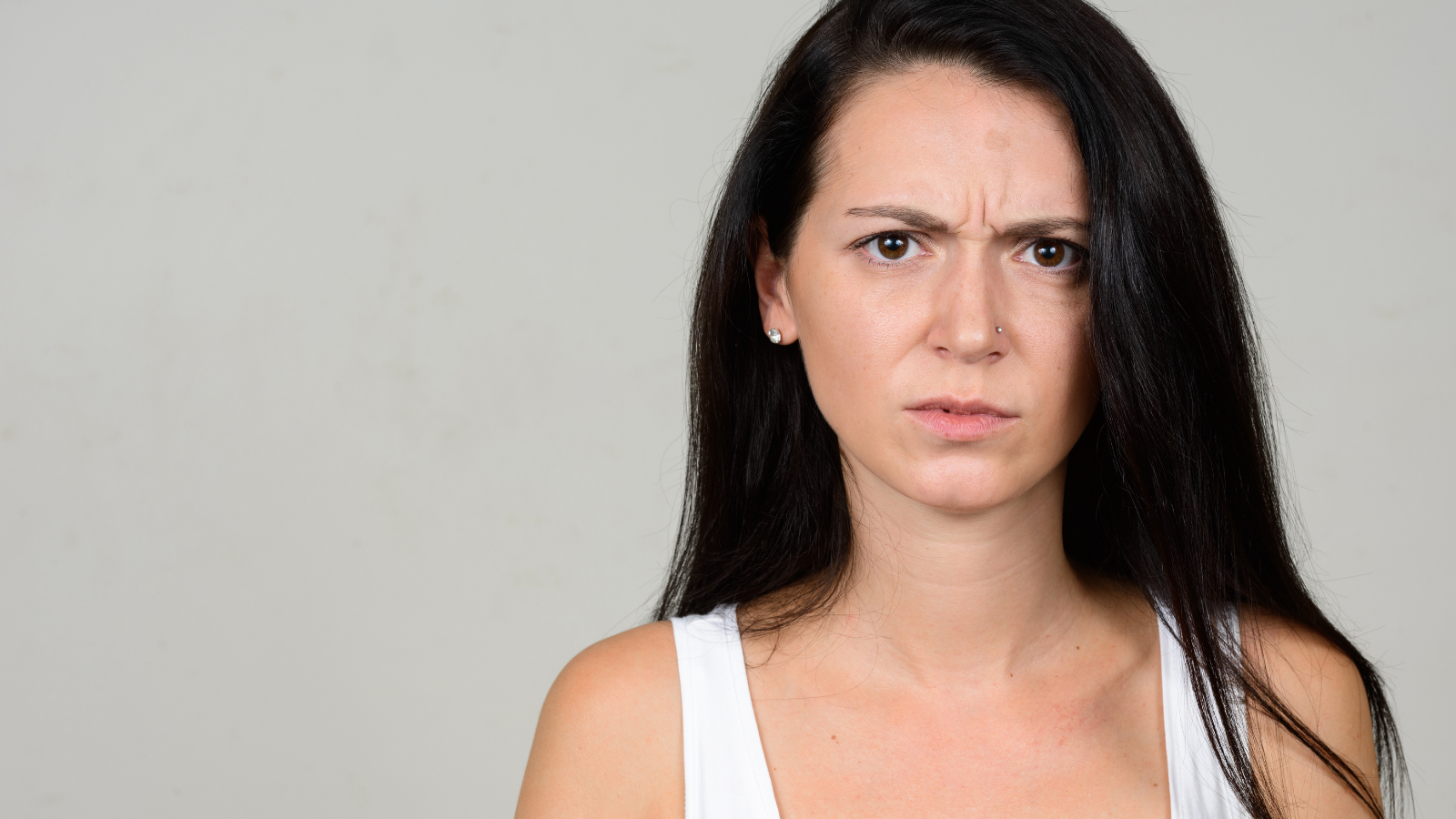 Daughter Reaches Her Limit With Her Stepmom’s Treatment Of The Family, And Says She’ll Never Be A Grandmother To Her Future Children woman staring at a camera annoyed