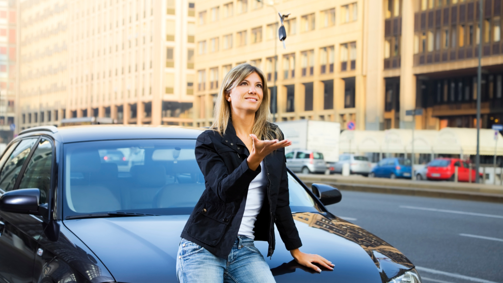 woman throwing car keys in the air