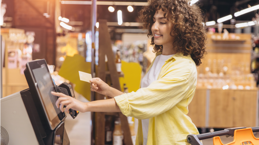 Curious Customers Tried to Get a Reaction From a Retail Employee—But Her Blunt Comeback Shut Them Down woman using self checkout at store