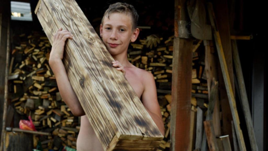 Kid stacking wood
