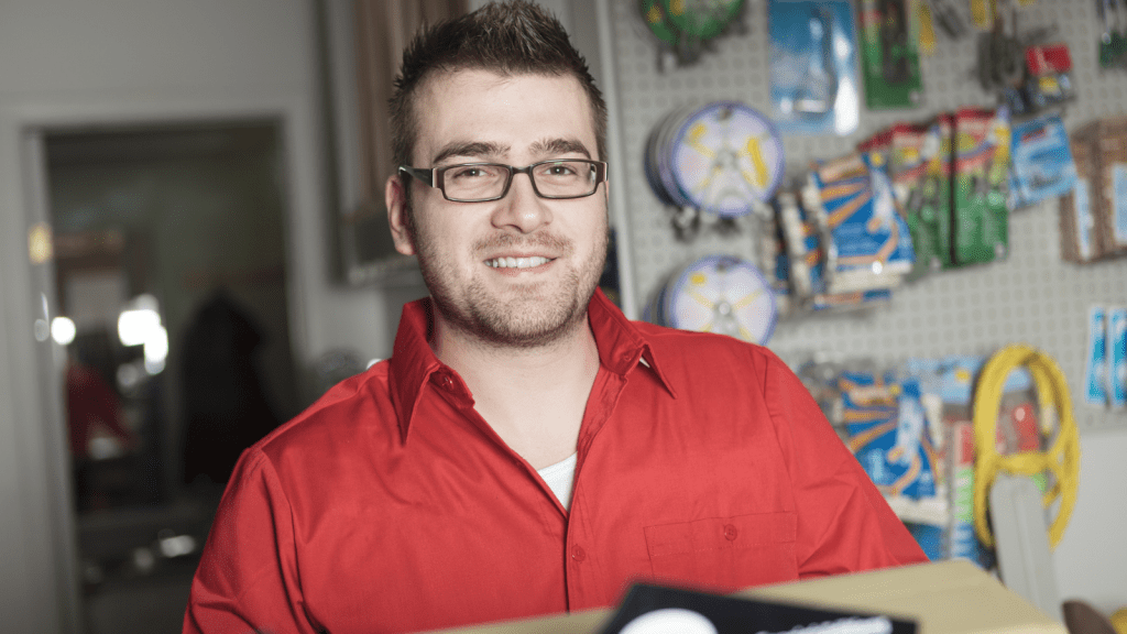 He Made a Scene Throwing Away His Receipt — Then Had to Dig It Back Out of the Trash young man smiling after getting back at a customer in hardware store