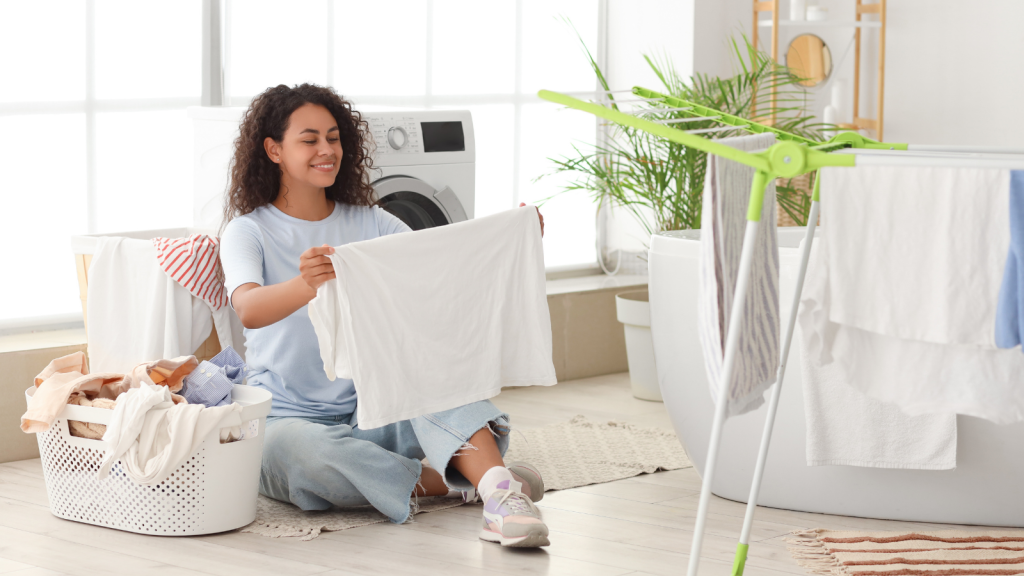 All She Wanted Was to Wash Her Clothes Herself — Somehow, It Became a Family Issue young woman doing laundry smiling