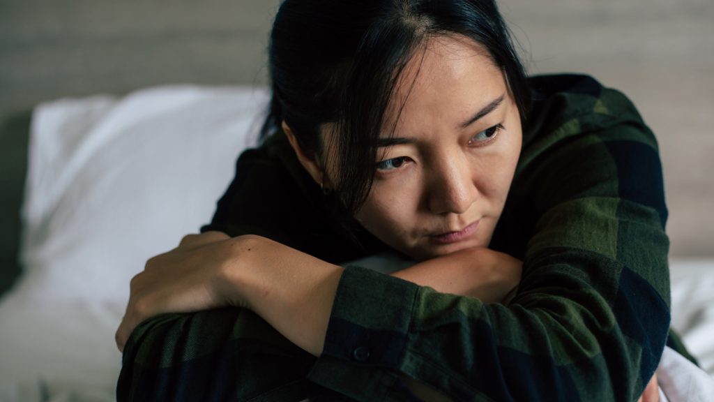 Older Sister Wants Her Younger Sibling’s Bedroom Because She’s Rarely Home—So Her Family Calls Her Ridiculous young woman hugging her knees deep in thought