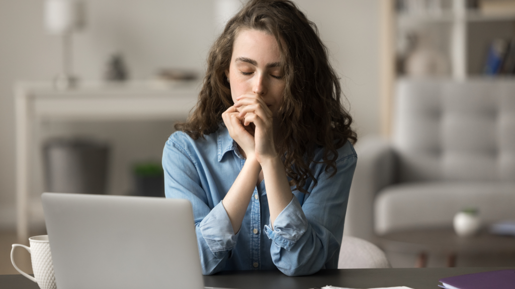 A Student Spent Years Fulfilling Her End of a Deal to Pay for College—Then Her Older Sister Backed Out and Stole Her Savings young woman thinking hard sitting at computer in home office