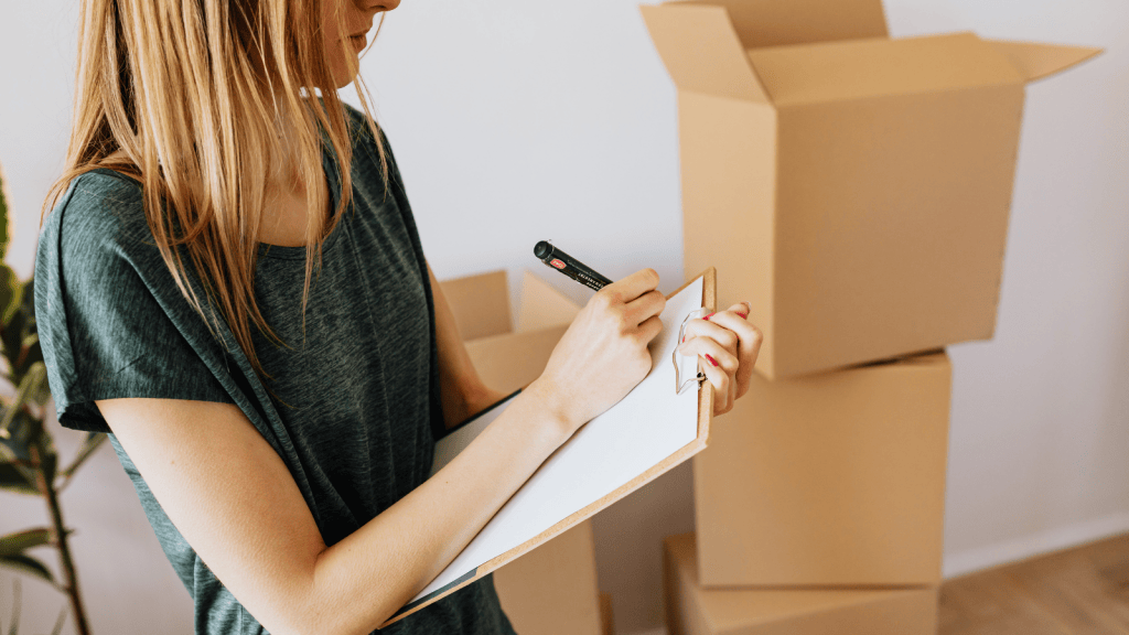 A woman packing moving boxes