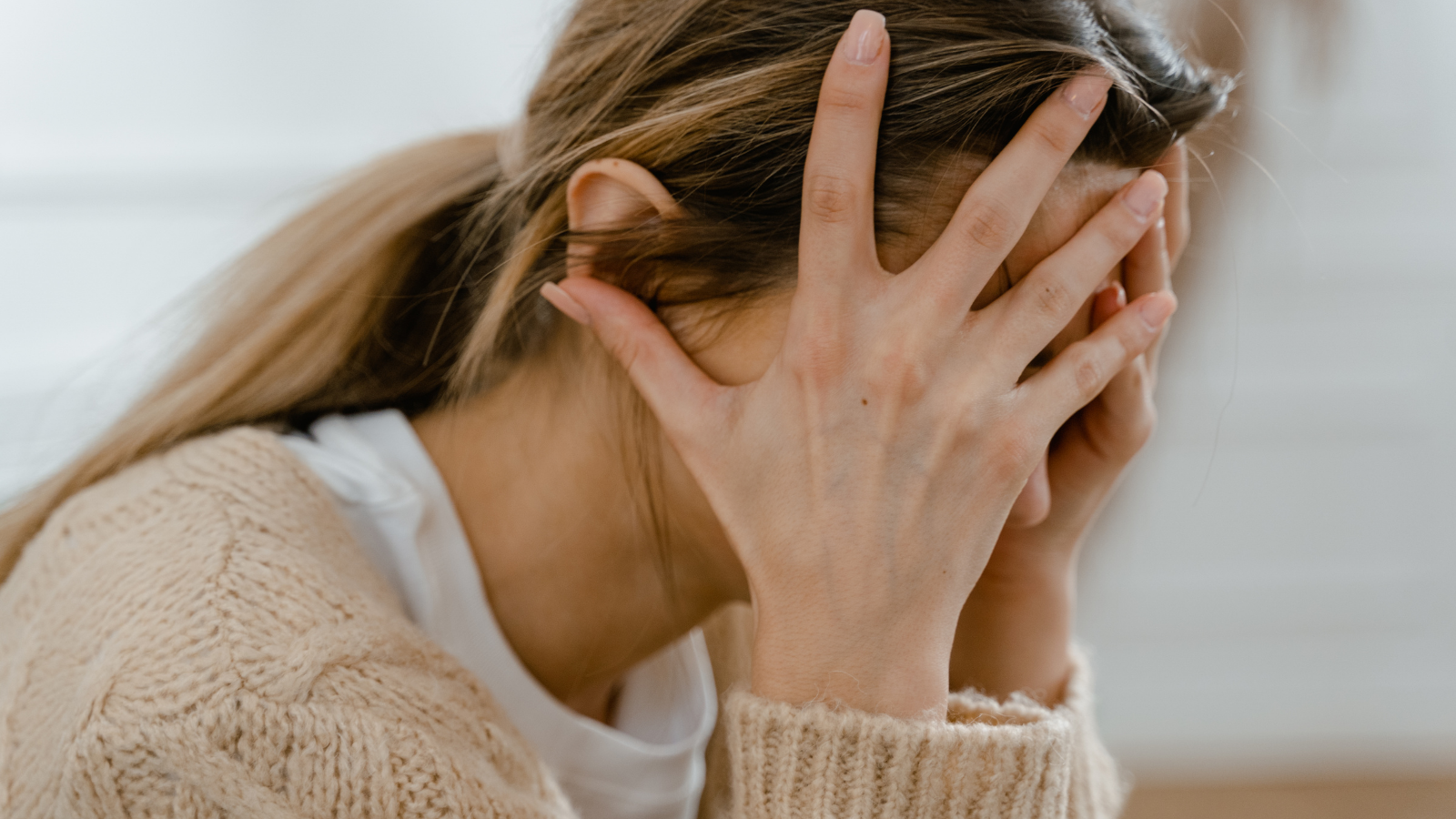 She Let Her Friend Move In Rent Free After A Breakup, But A Year Later, Her Friend Keeps Demanding More A woman with her head in her hands