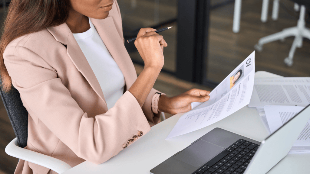 A Resume Claim Caught Her Eye During A Credential Check — It Simply Didnt Make Sense HR manager looking at a candidate's resume