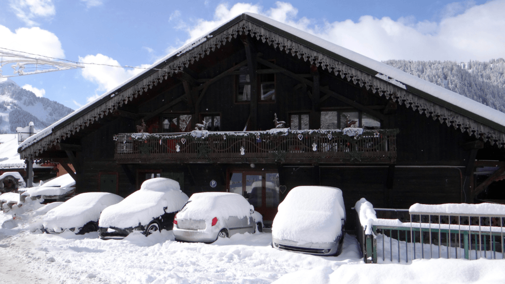 He Watched A Customer Trudge Through Deep Snow To Reach The Store, Then Had To Break The News That The Entrance Had Moved Store and cars covered in snow