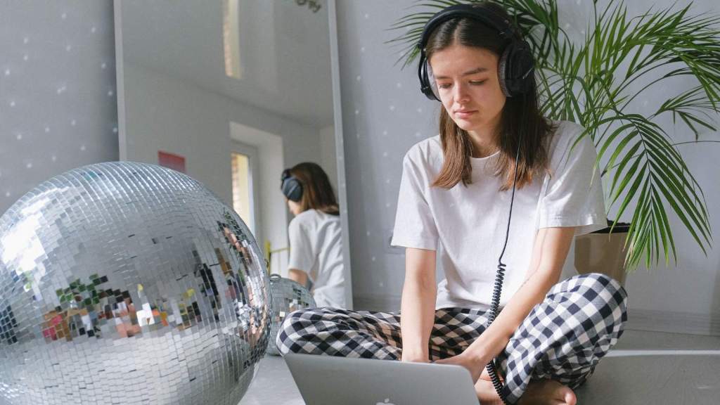 Woman wearing noise-cancelling headphones in her room