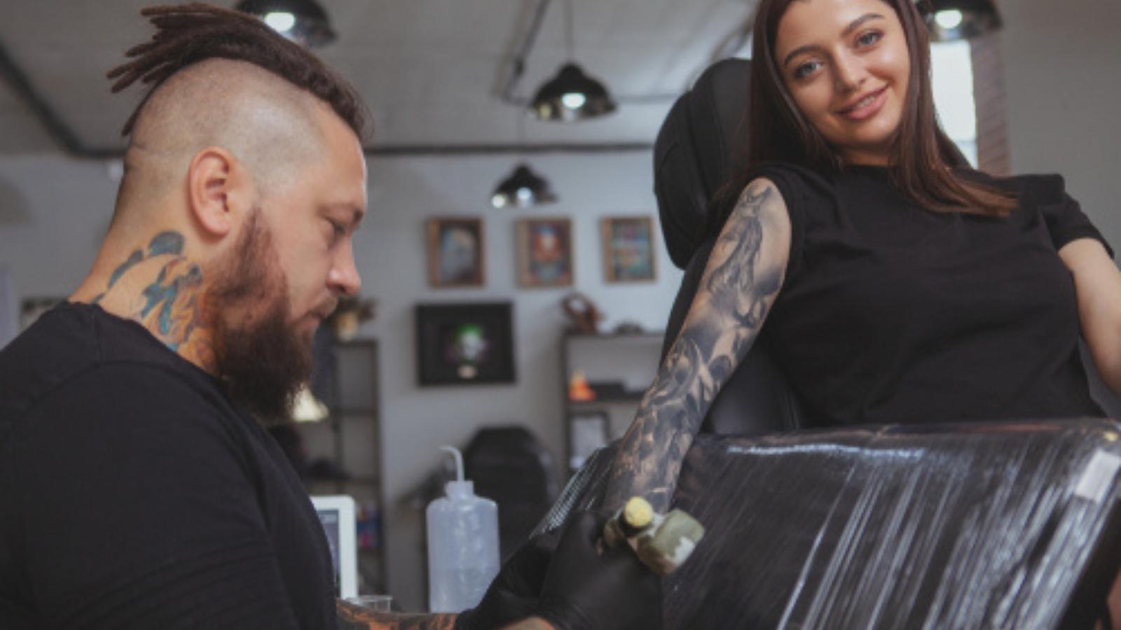Woman getting a tattoo