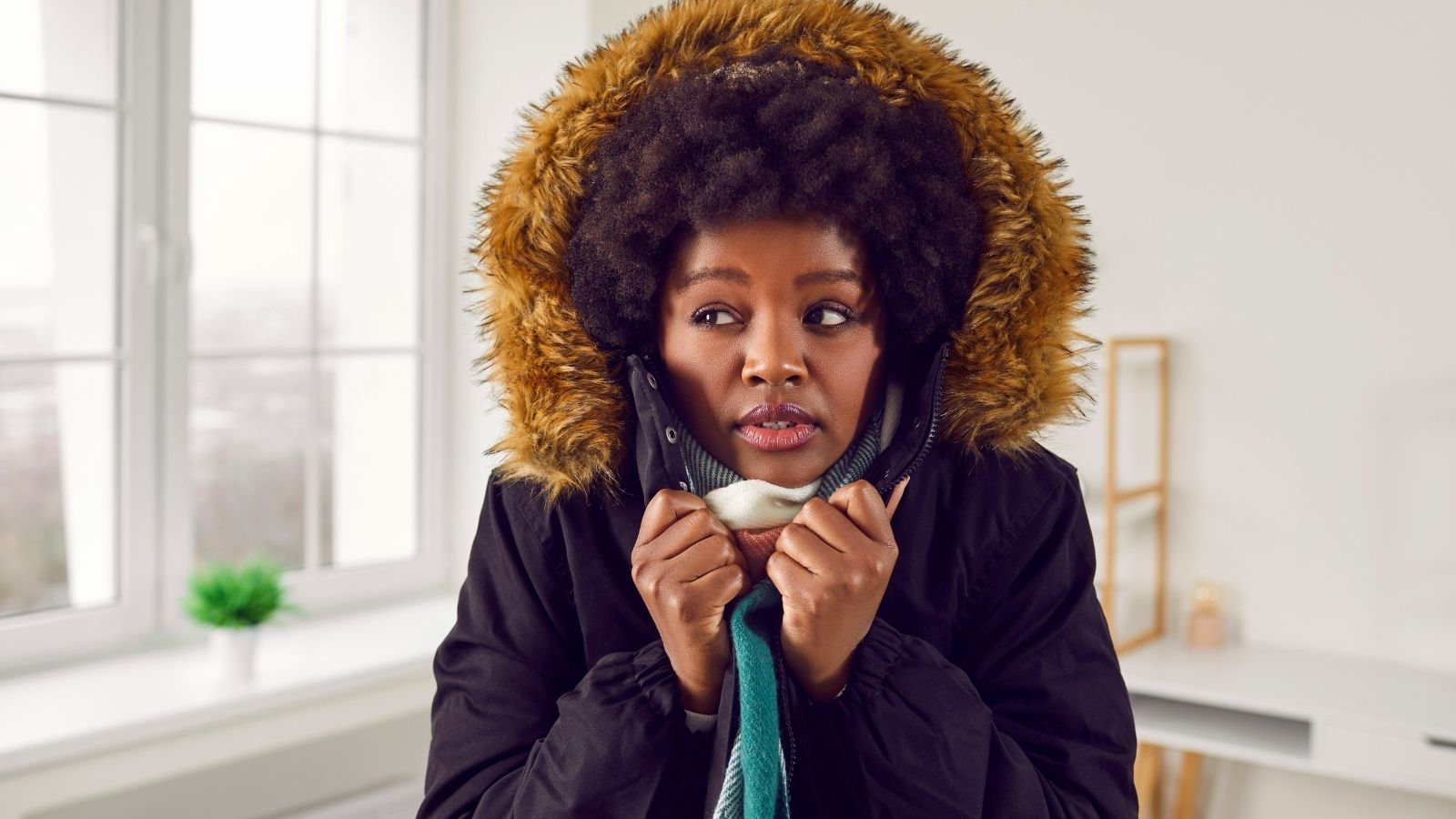 They Moved Into A Non Smoking Apartment, But When A New Neighbor Started Smoking Downstairs, They Turned Off The Heat To Fight Back woman wearing a parka inside