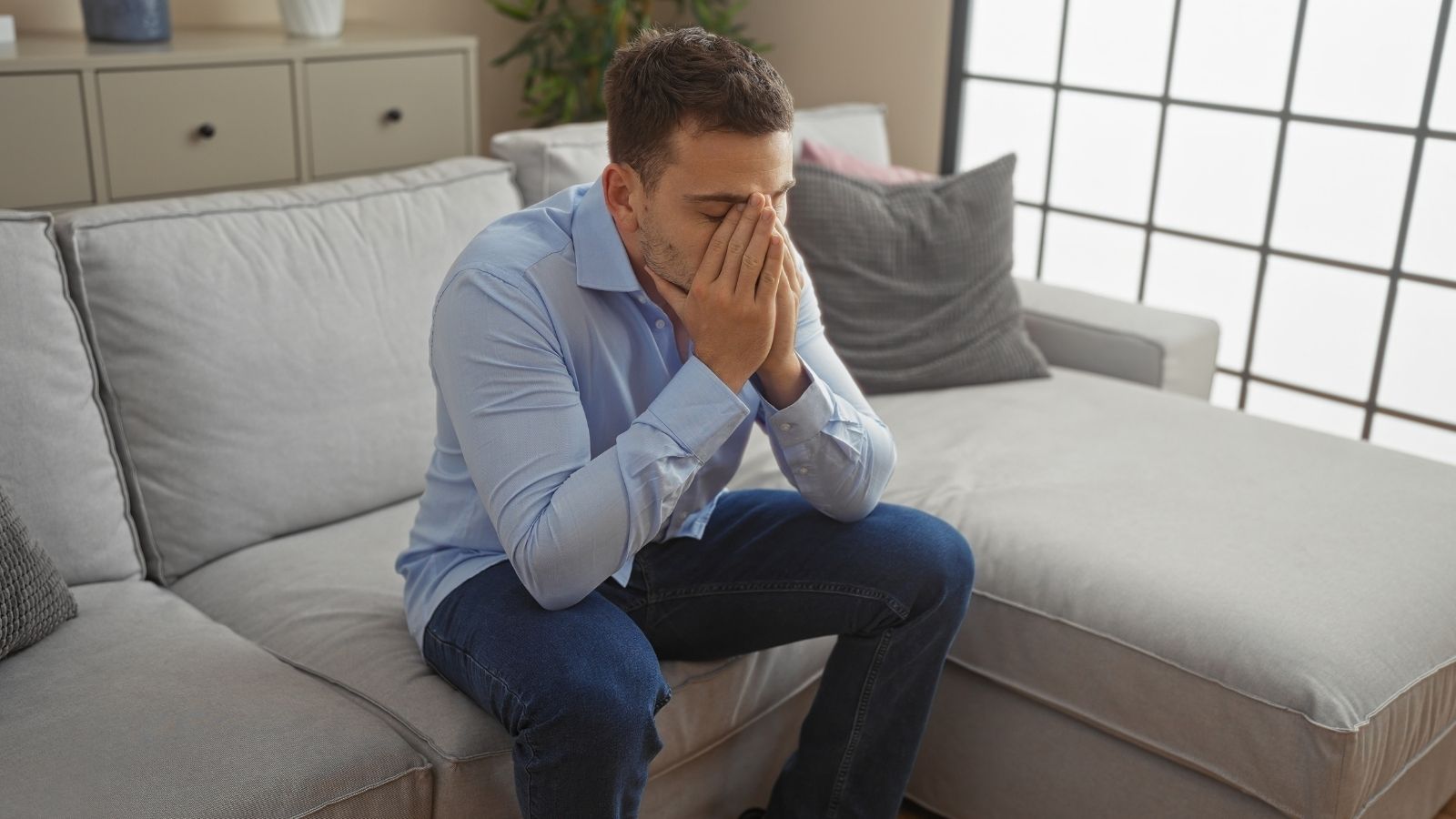 His Neighbors Termite Treatment Requires Tenting The House, But That Means Stepping Onto His Property Too stressed out man sitting on a couch