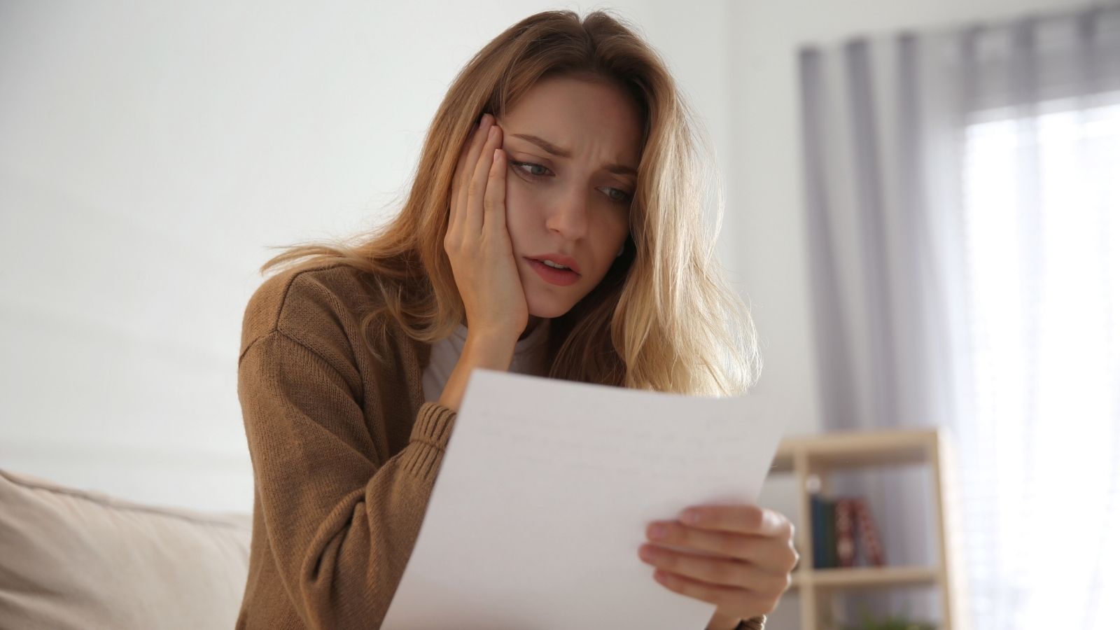A Teacher Had Students Write Letters To Business Owners — One Owner Called The Assignment Unethical And Scammy woman looking concerned while reading a letter