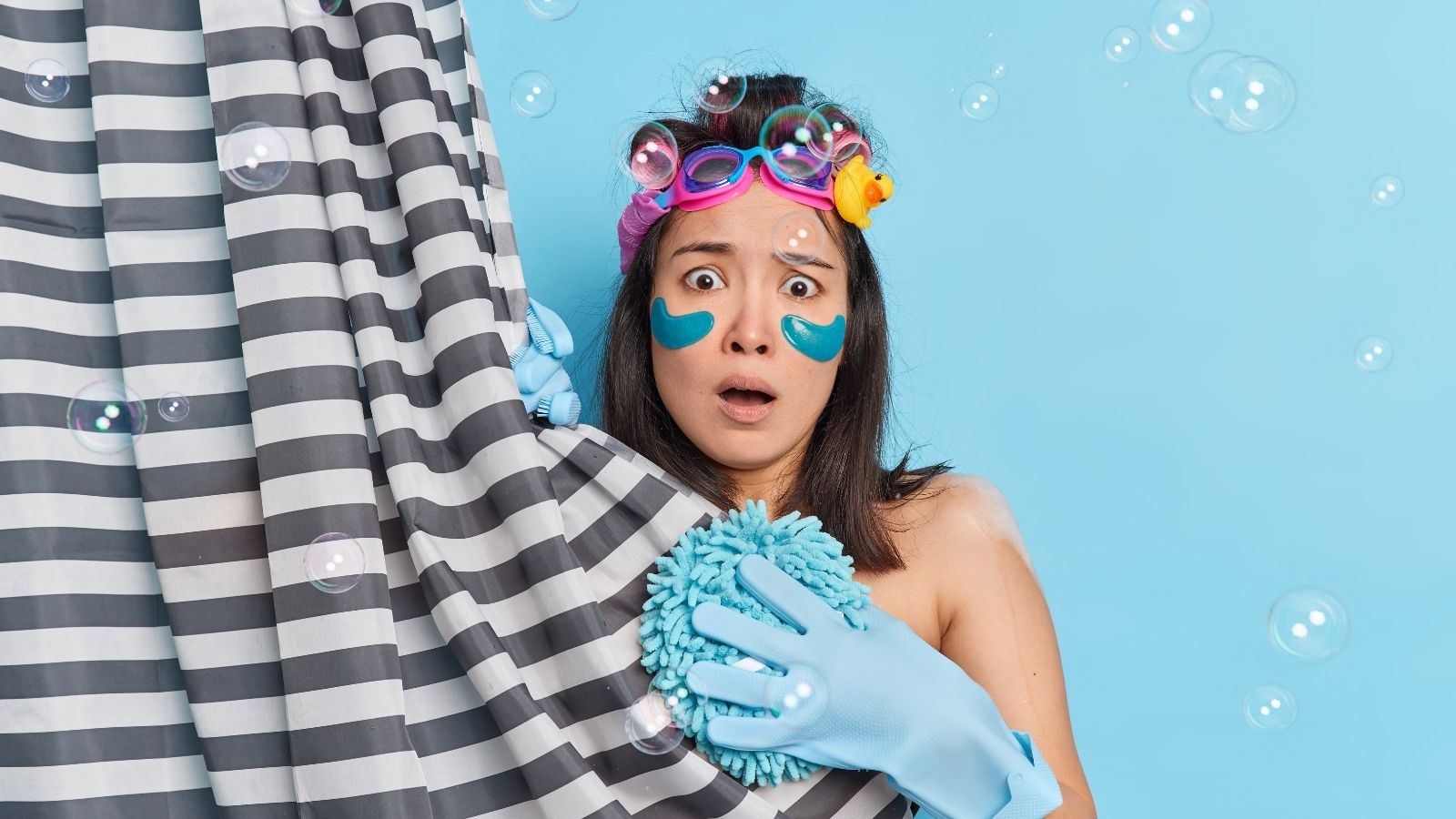 She Was Showering When A Maintenance Worker Opened Her Bathroom Door, And Now She Doesnt Feel Safe In Her Own Home scared woman looking out from behind a shower curtain
