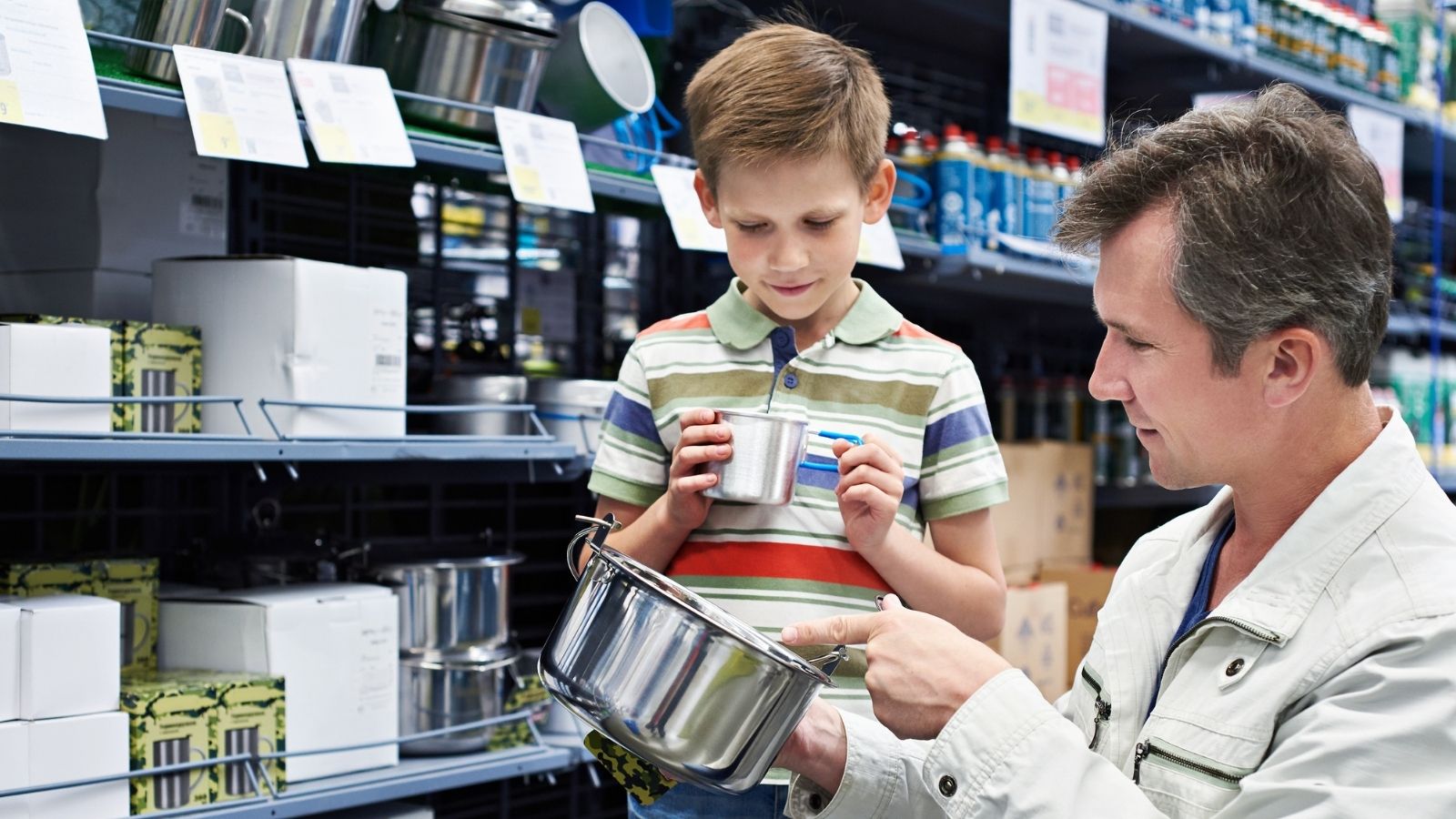 Retail Worker Helped A Dad And Son Get Everything They Needed For Boy Scouts, But One Sale Changed Their Lives father and son picking out camping supplies