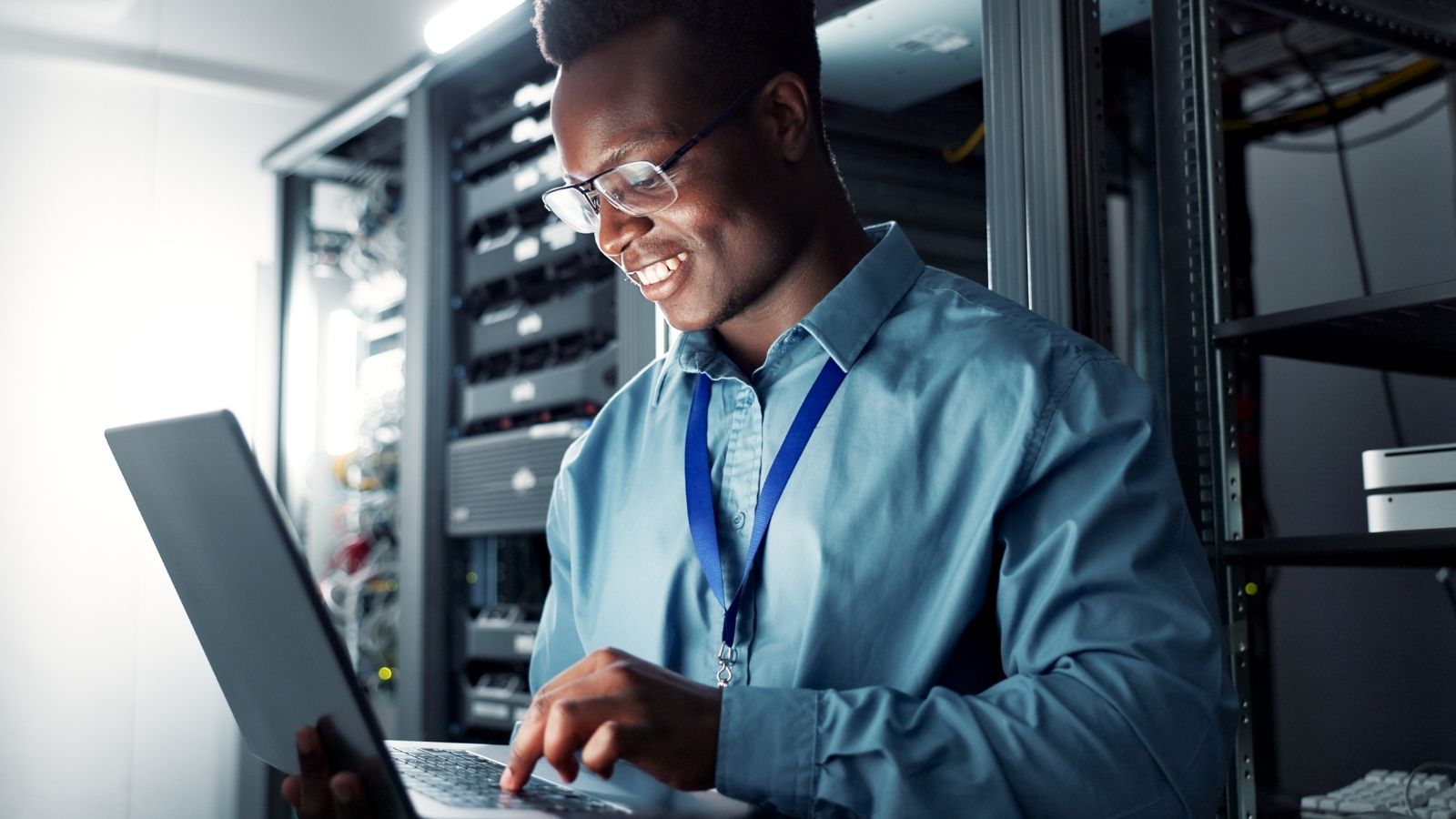 An IT Employee Was All About Saving Energy, Until The Landlord Crossed Him — Then He Got Payback smiling man using a laptop in a server room