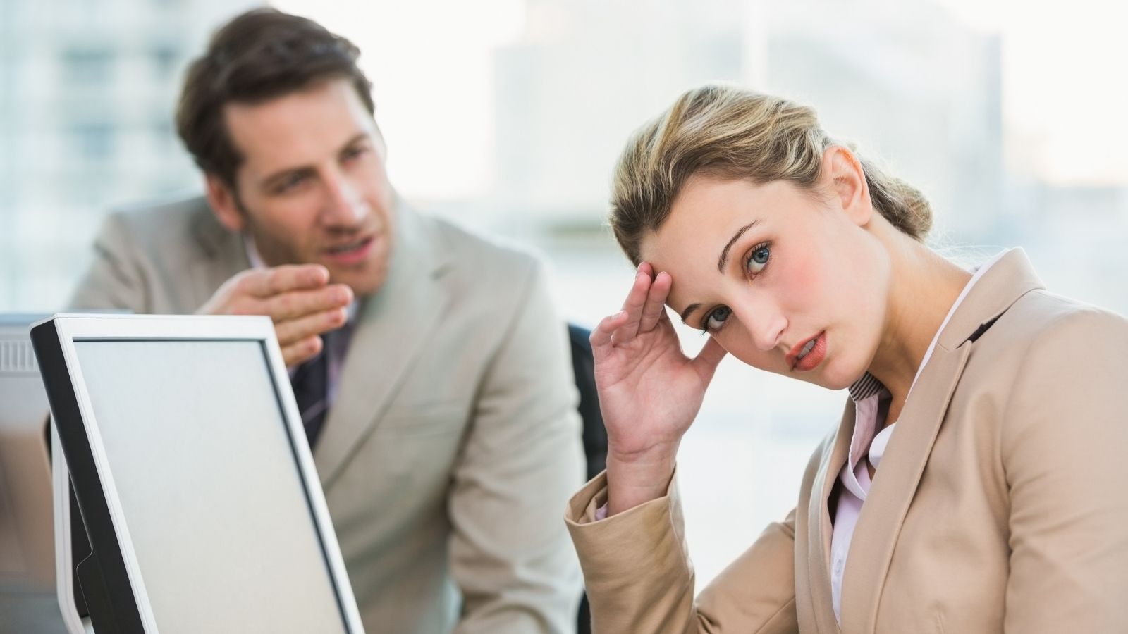 businesswoman annoyed with male coworker