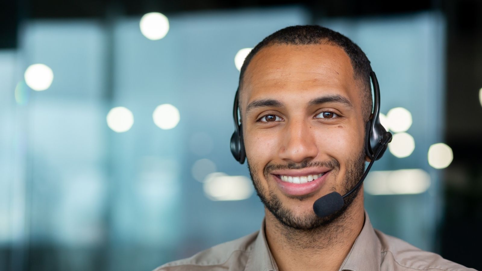 closeup of a smiling man wearing a headset