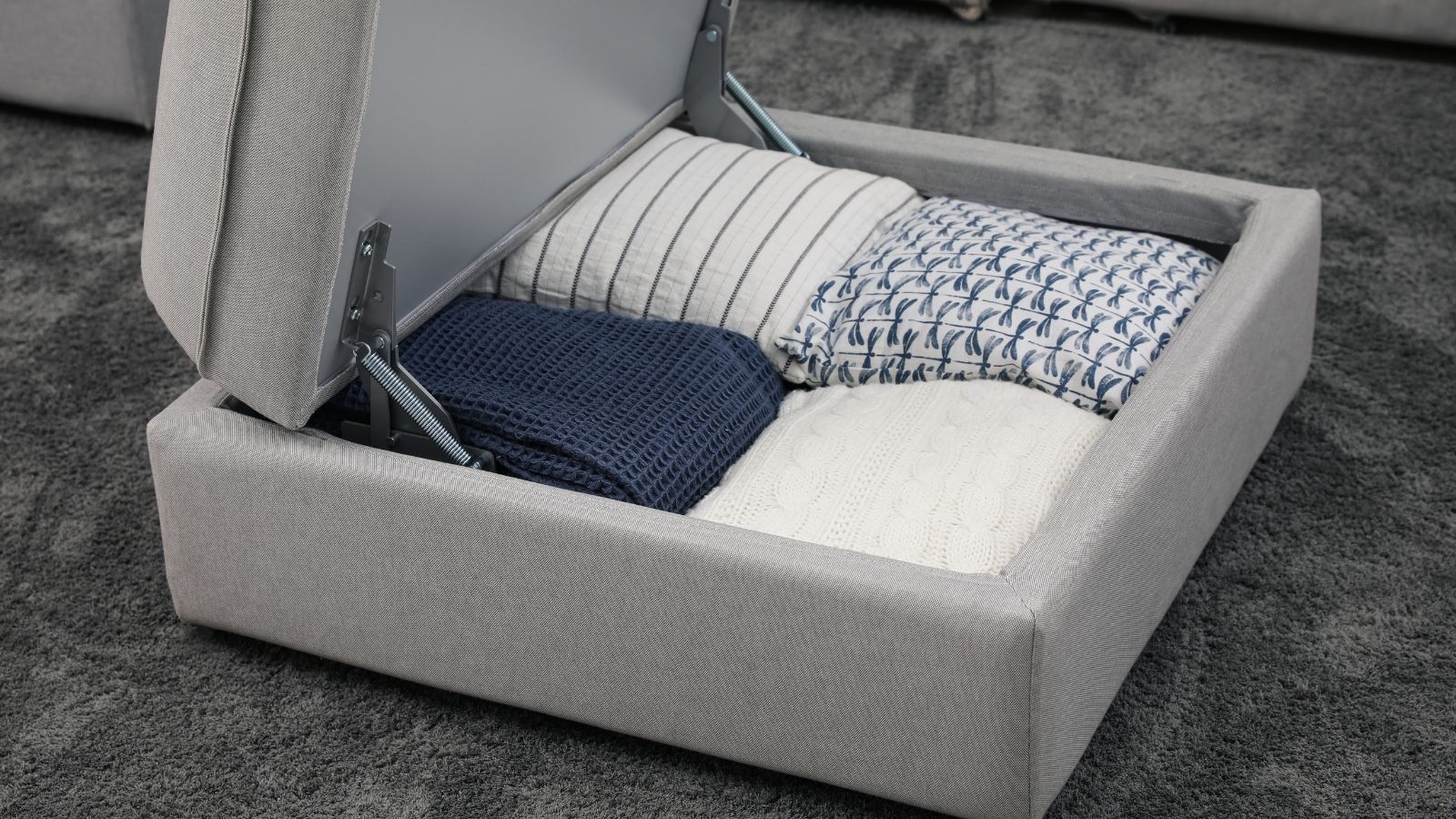 open storage ottoman with blankets inside