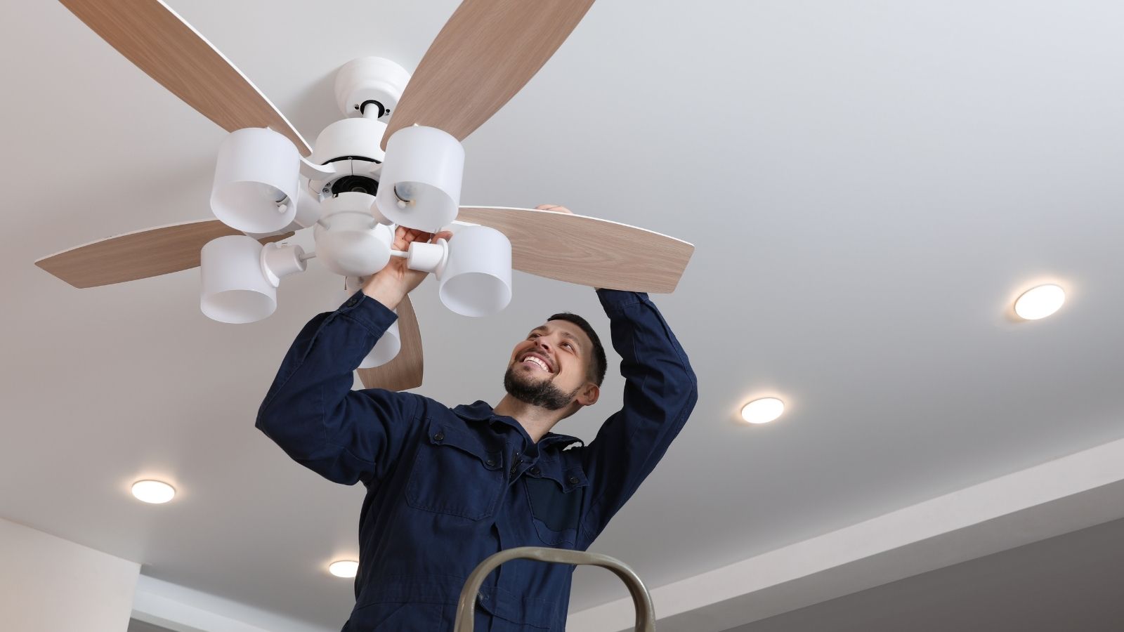 man installing a ceiling fan