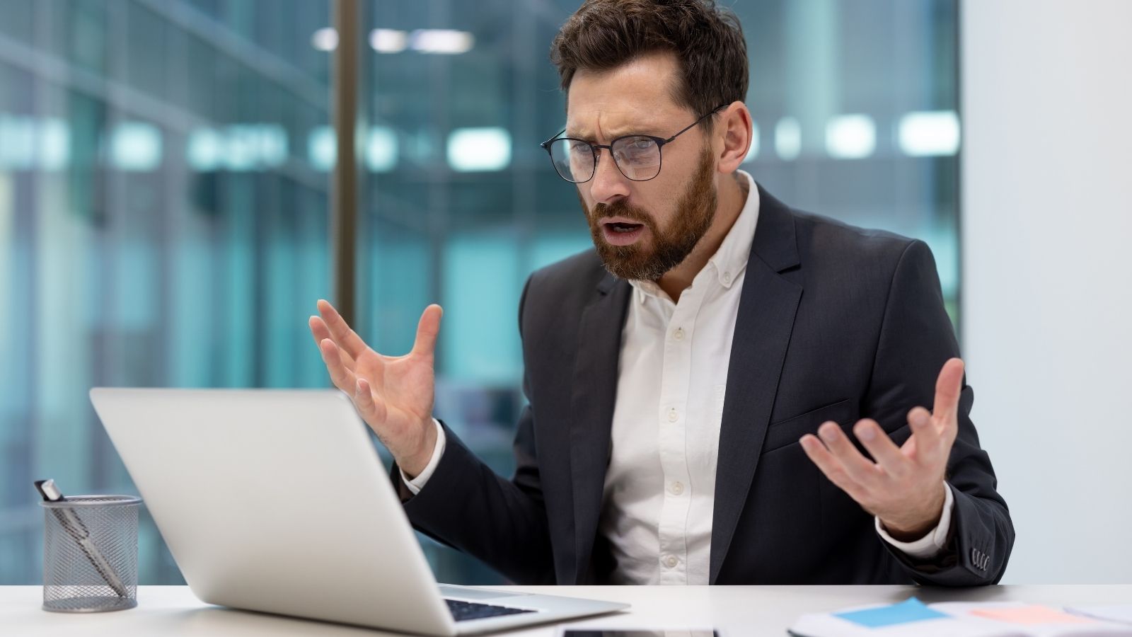 worried businessman looking at a laptop computer