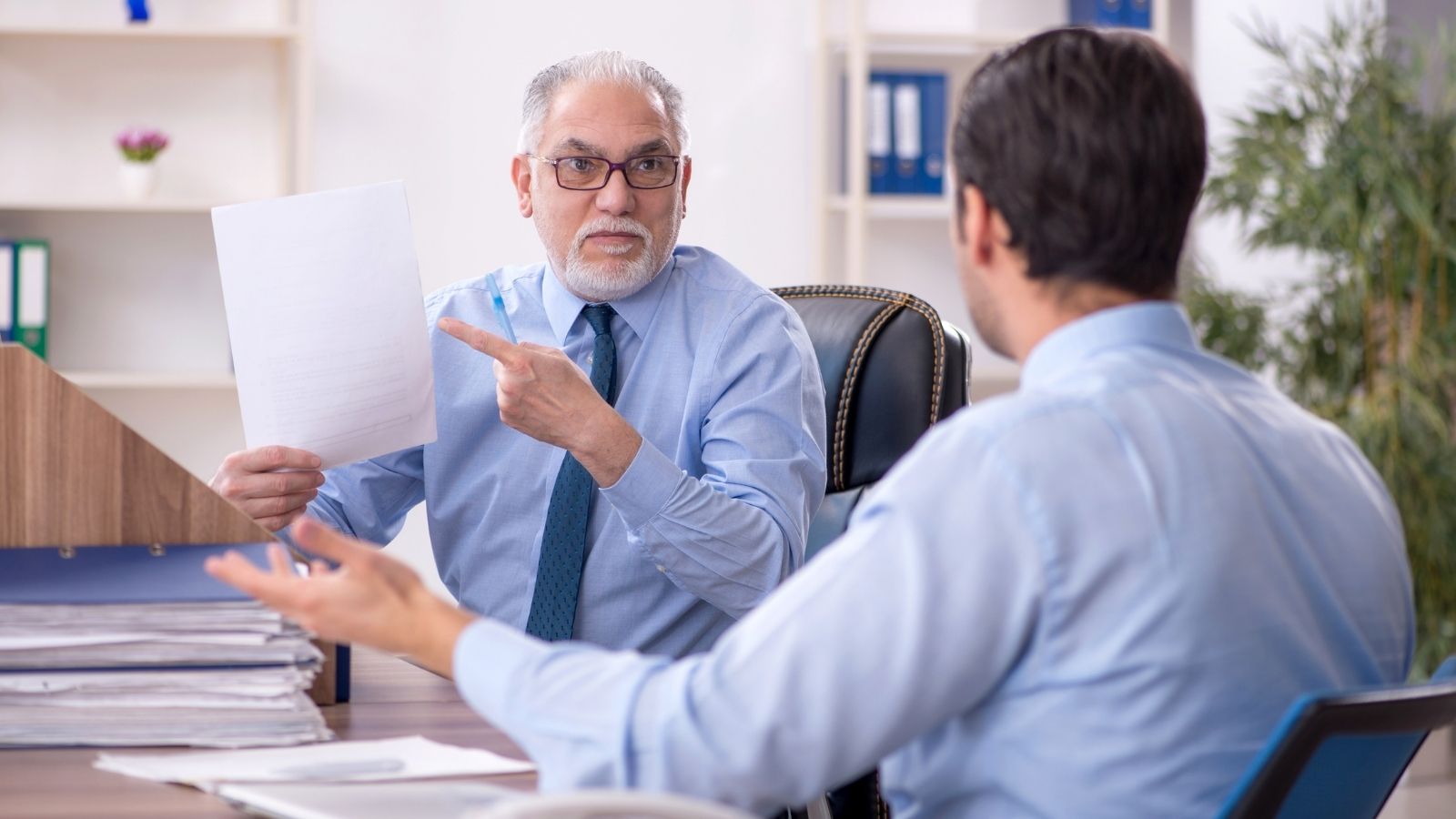 older and younger businessman arguing
