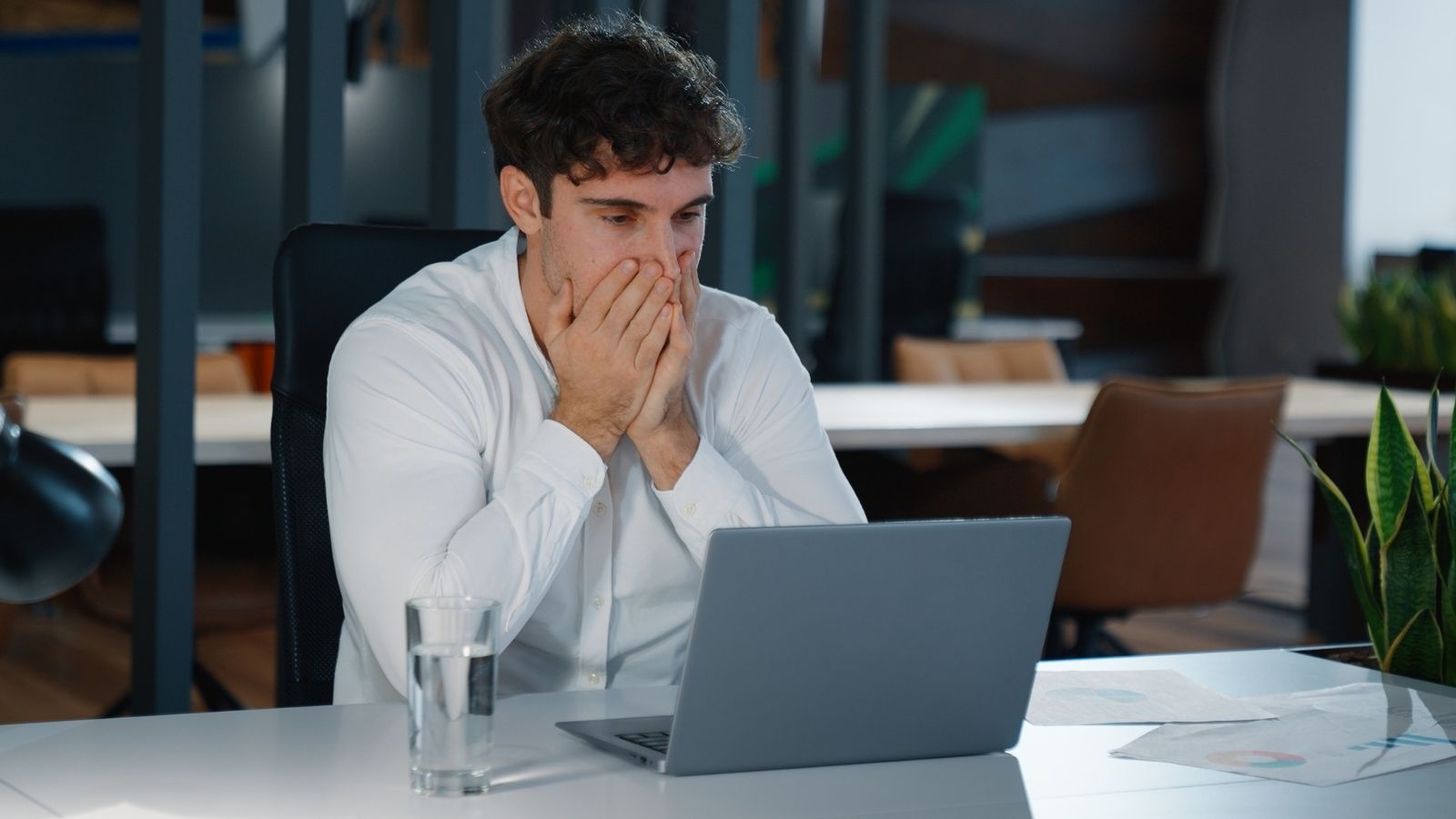 worried businessman looking at laptop computer