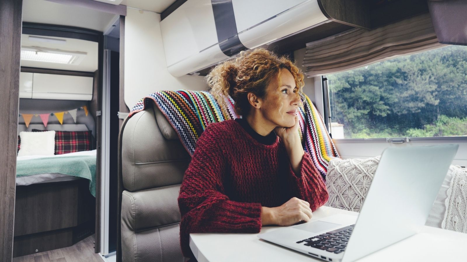 woman sitting in an RV looking outside