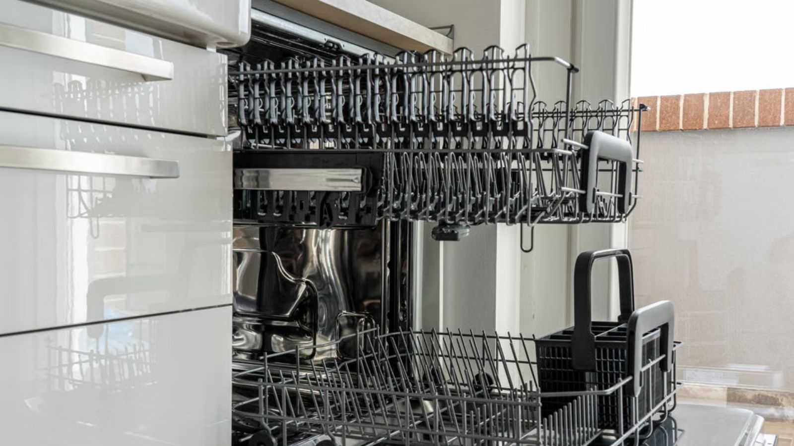 She Claimed DIY Guys Just Hack Things Together—Until Her New Dishwasher Sat Uninstalled in Her Kitchen An empty diswasher in a modern kitchen