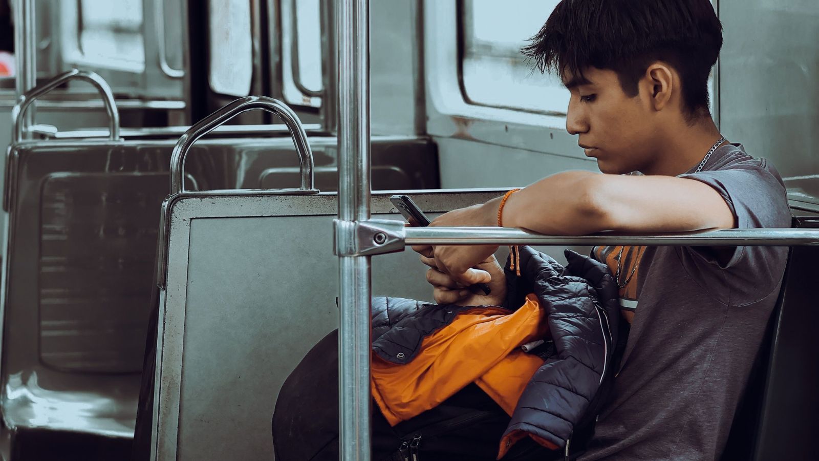 A young man texting on a train