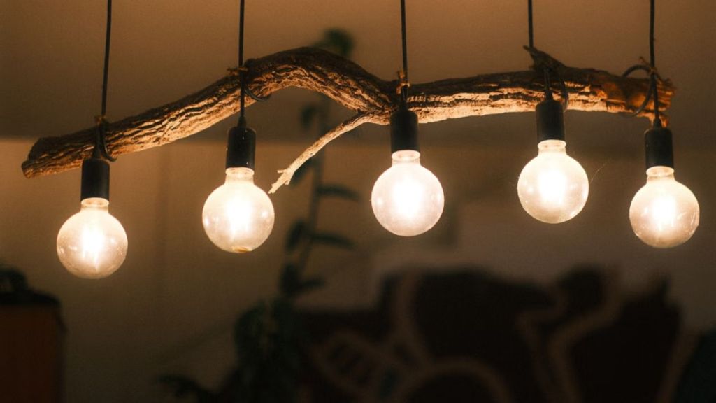 Five light bulbs lined up hanging inside a dim room