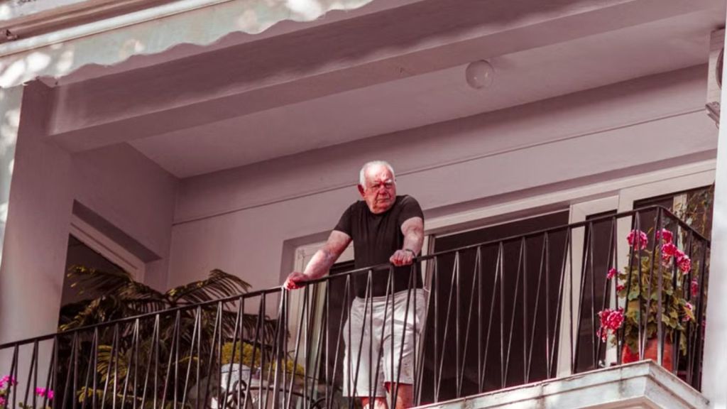 An old man standing on the balcony