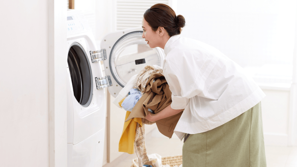 Woman using a washing machine