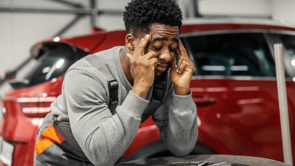car mechanic with frowning face