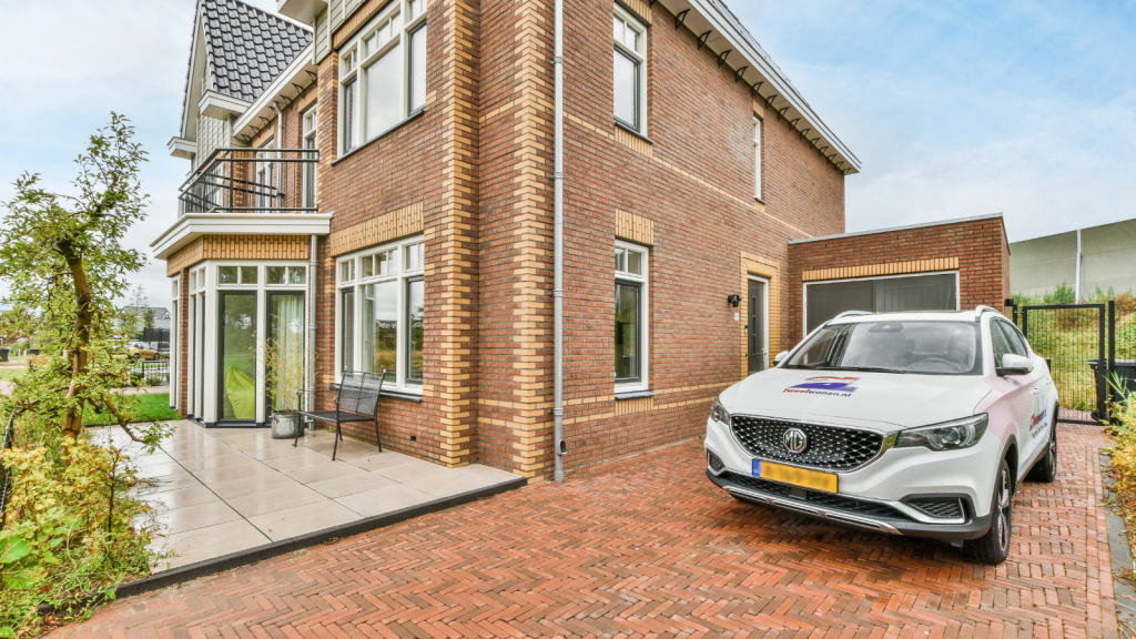 HOA Capped Driveway Parking at Two Cars—So He Parked 4 Vehicles on the Narrow Street car parked in big driveway in front of brick house