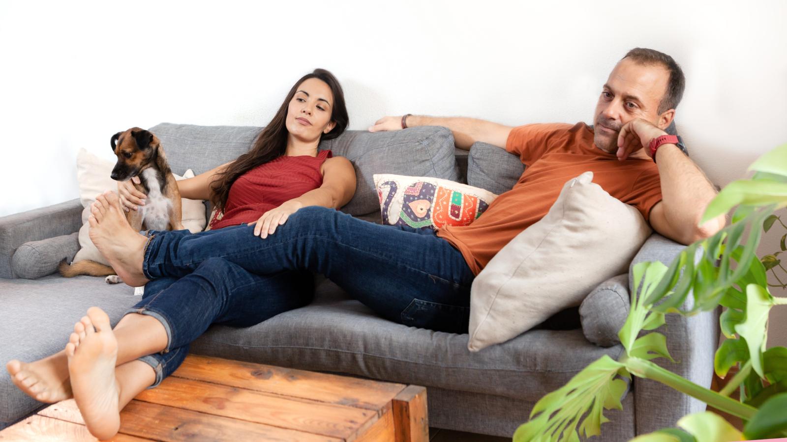 couple on a couch with a dog