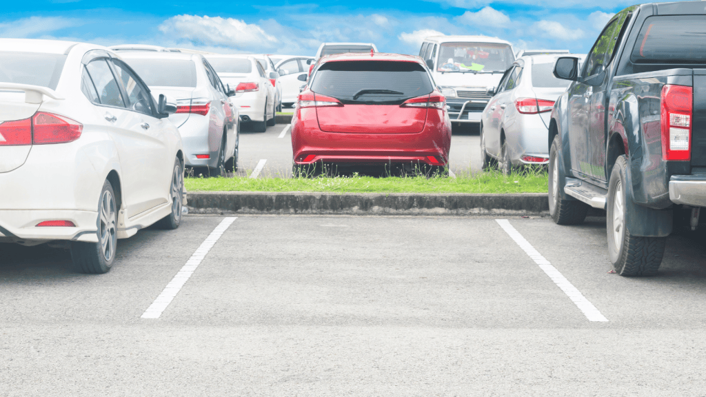 Man Stood In A Parking Spot To Save It For His Mother, But An Arriving Car Put An End To His Plan empty parking space in busy parking lot