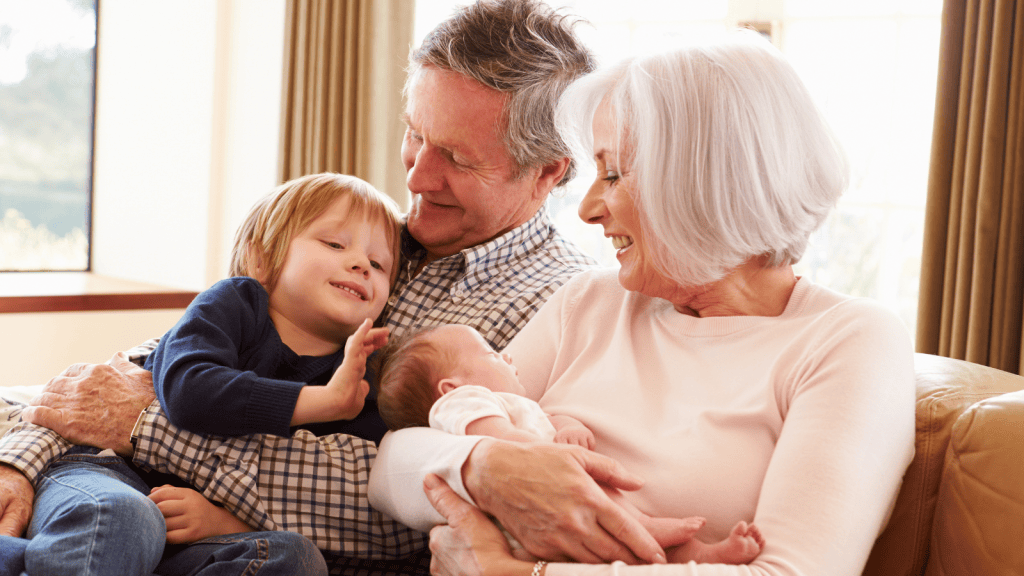 happy grandparents holding grandchild