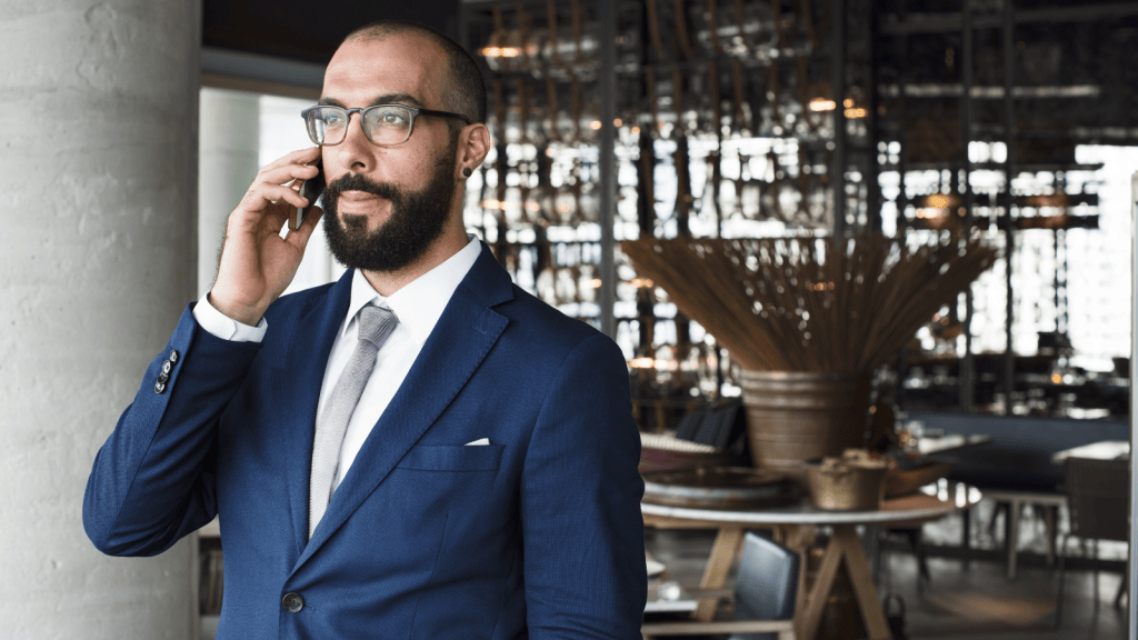 man in suit in restaurant talking on phone