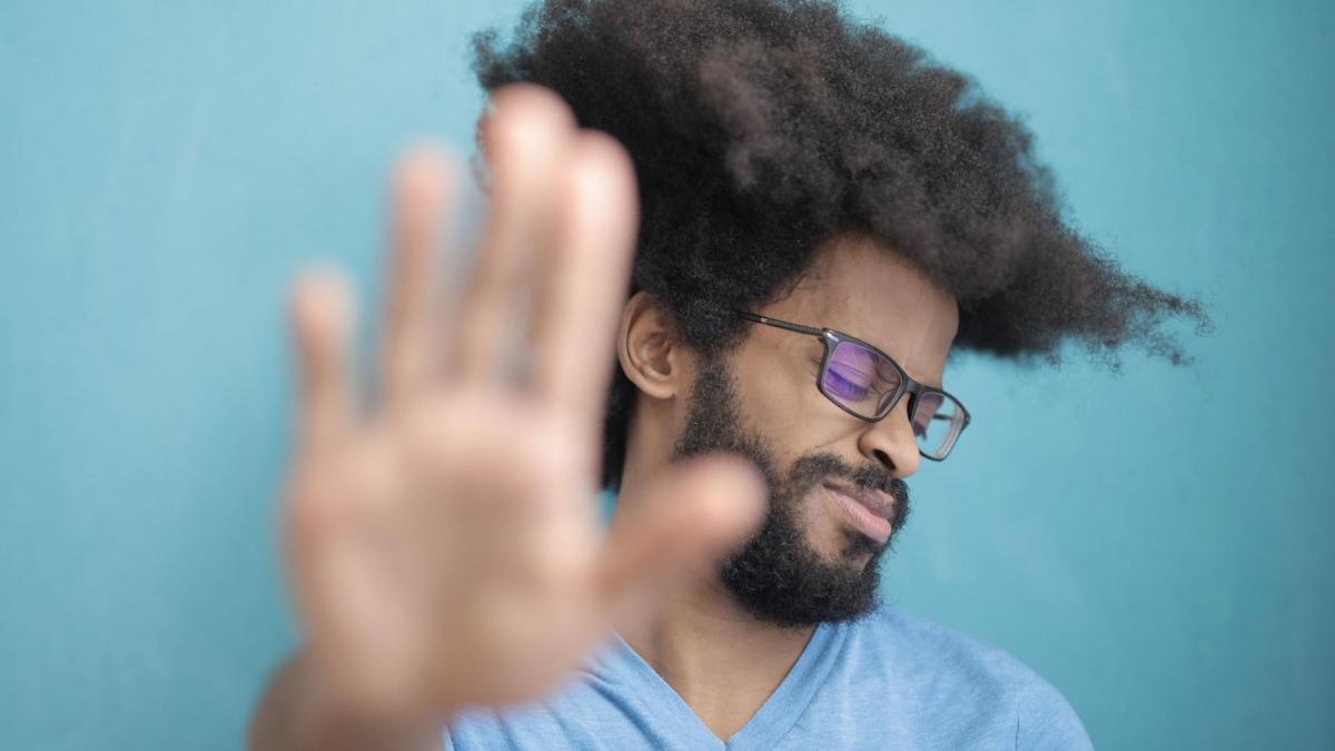 man putting his hand up saying no