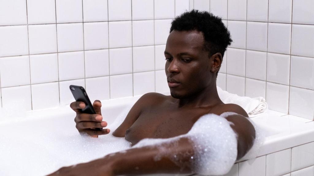 man soaking in a bubble bath