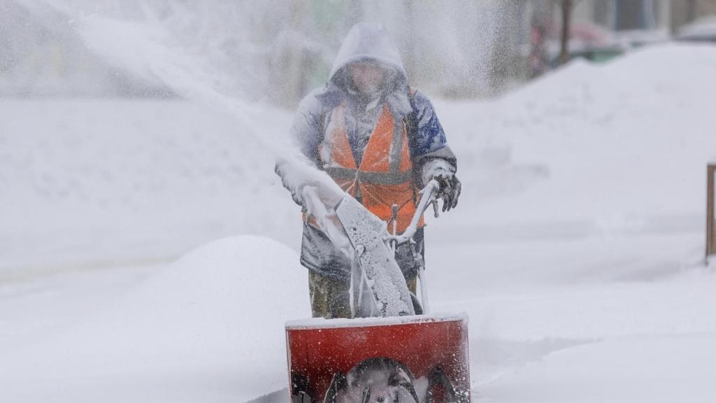 man using a snowblower
