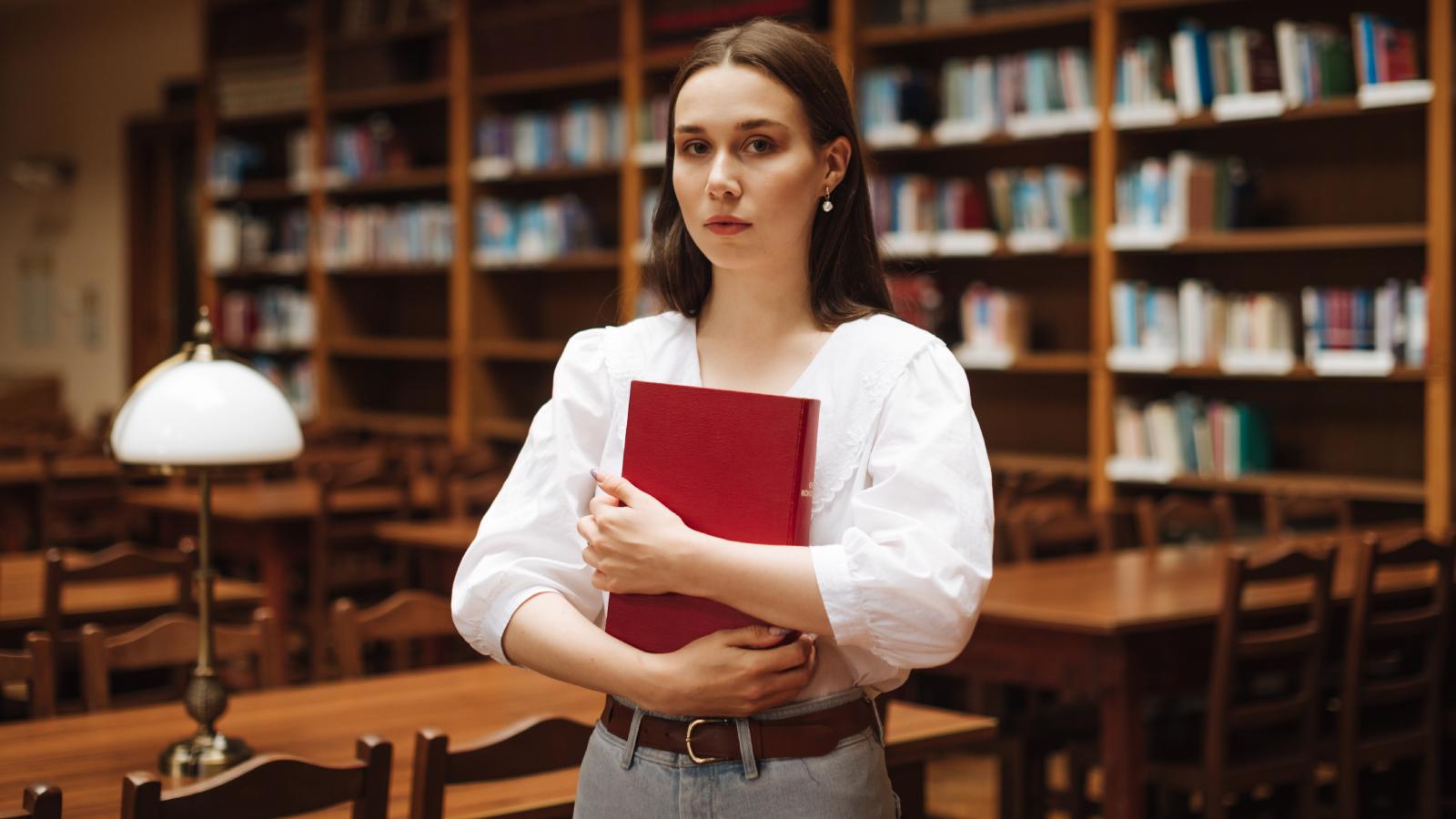 Her Father Dictated Her Entire Life Plan—Until She Secretly Applied to Distance Medical Schools Behind His Back woman in a library