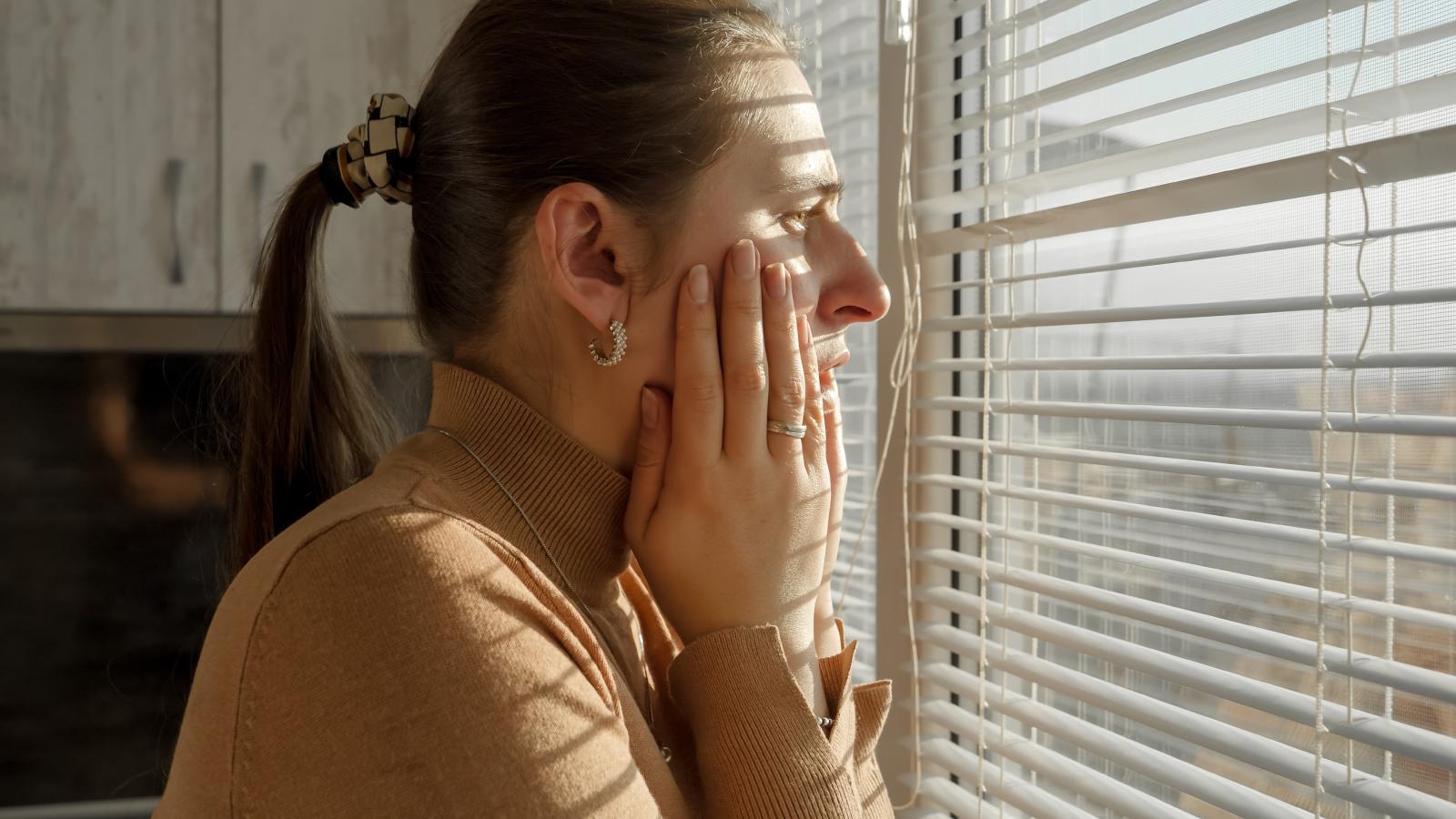 Her Neighbors Wont Clean Up After Their Dogs, And Every Complaint Seems To Escalate The Drama Even More woman looking out her window